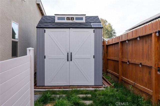 view of shed with a fenced backyard