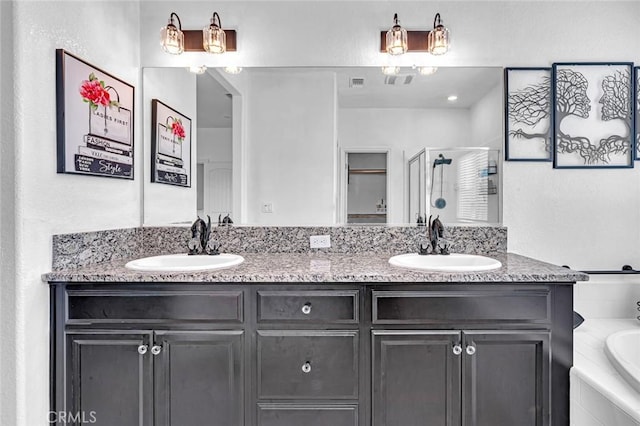 bathroom with double vanity, a stall shower, a sink, and a bath