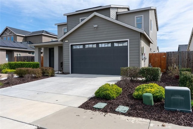 view of front of house featuring driveway and fence