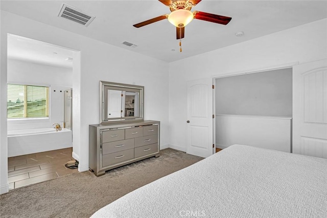 carpeted bedroom with baseboards, visible vents, and a ceiling fan