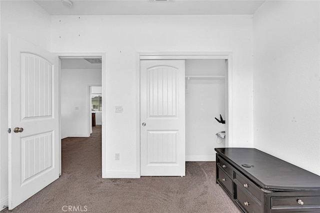 unfurnished bedroom with carpet floors, a closet, and baseboards