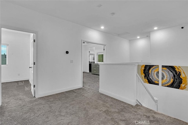 carpeted empty room with baseboards and recessed lighting