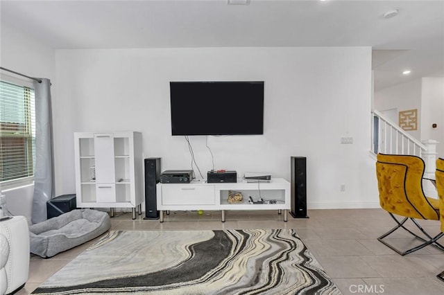 living room featuring tile patterned flooring, baseboards, and recessed lighting