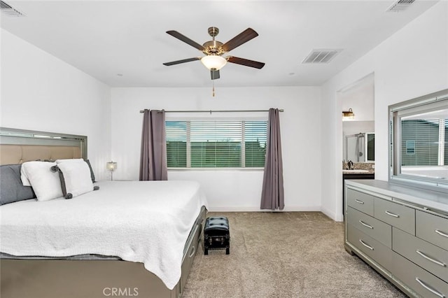 bedroom with visible vents, light carpet, and baseboards