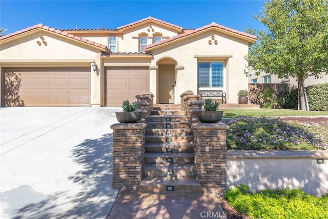 25499 Foxglove Ln, Corona, CA 92883 - mediterranean / spanish-style house featuring an attached garage, a tiled roof, driveway, and stucco siding
