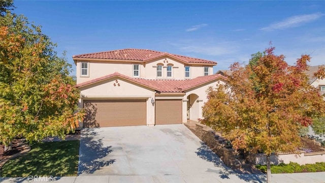 25499 Foxglove Ln, Corona, CA 92883 - mediterranean / spanish-style house featuring an attached garage, a tile roof, concrete driveway, and stucco siding