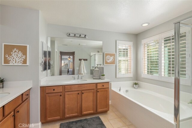 25499 Foxglove Ln, Corona, CA 92883 - full bath with a garden tub, two vanities, tile patterned flooring, and a sink