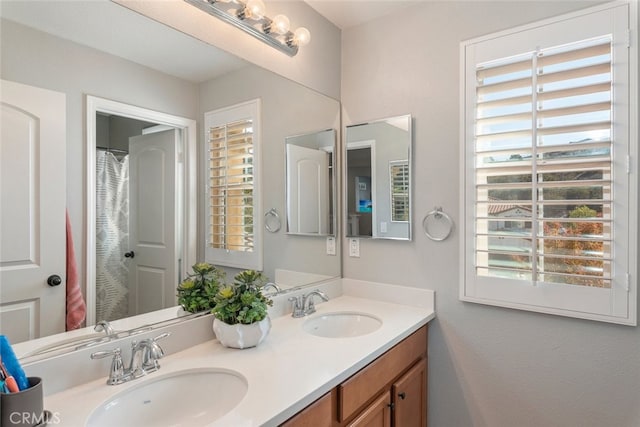 25499 Foxglove Ln, Corona, CA 92883 - bathroom featuring a sink, double vanity, and a healthy amount of sunlight