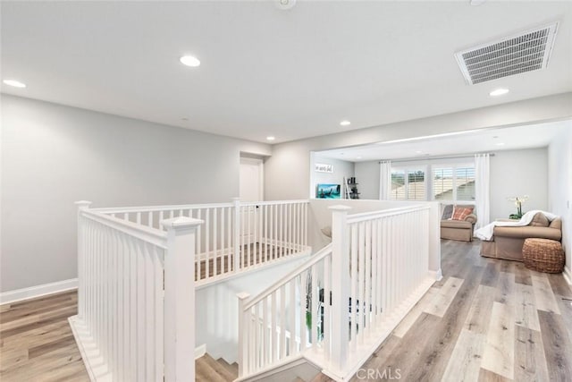 25499 Foxglove Ln, Corona, CA 92883 - corridor featuring wood finished floors, an upstairs landing, visible vents, and recessed lighting