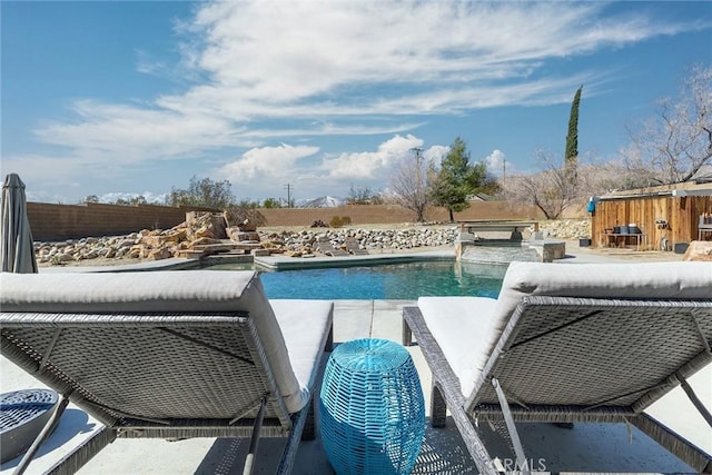 view of pool featuring a patio area, a fenced backyard, and a fenced in pool