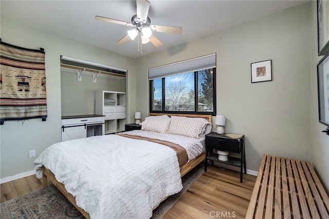 bedroom featuring ceiling fan, wood finished floors, and baseboards