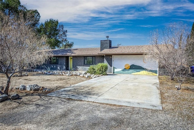 ranch-style house featuring driveway, a chimney, an attached garage, and stucco siding