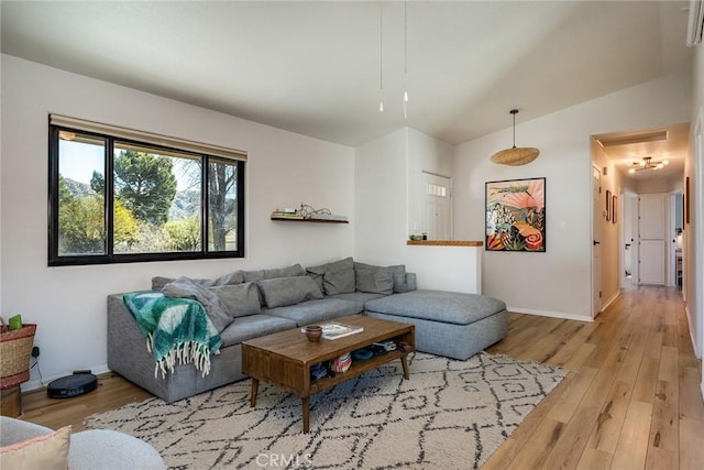 living area featuring baseboards and wood finished floors