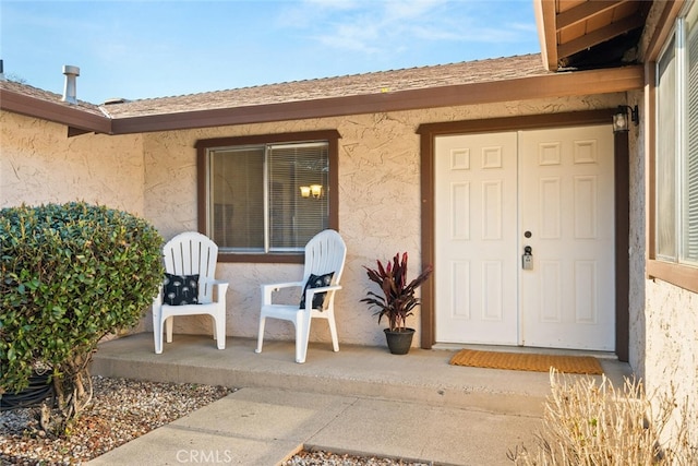 property entrance featuring stucco siding