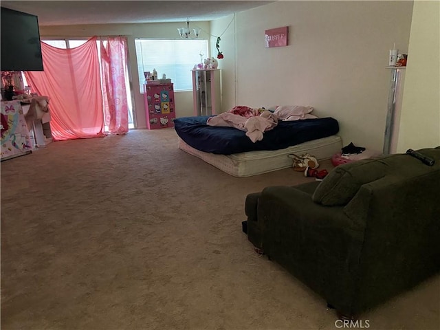 bedroom with a chandelier and carpet flooring