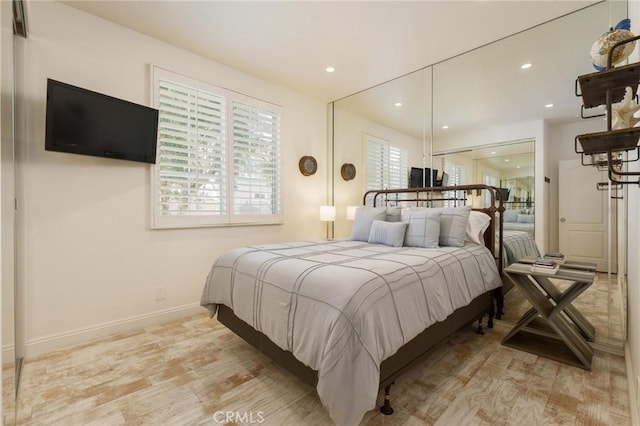 bedroom featuring recessed lighting, light wood-style flooring, and baseboards