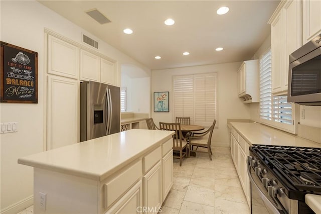 kitchen with light countertops, appliances with stainless steel finishes, visible vents, and recessed lighting