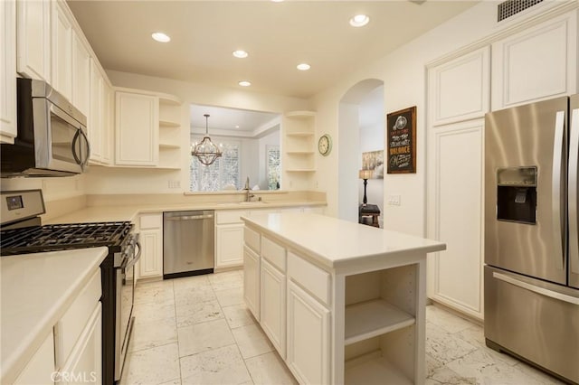 kitchen with visible vents, stainless steel appliances, light countertops, open shelves, and recessed lighting