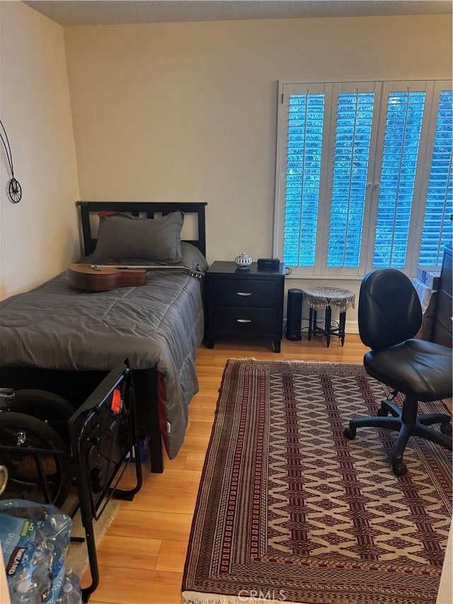 bedroom featuring light wood-style floors