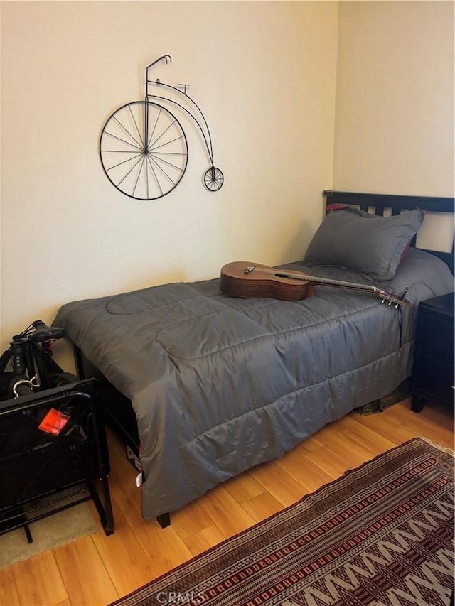 bedroom with wood finished floors