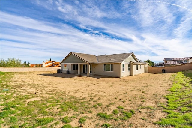 rear view of property with fence