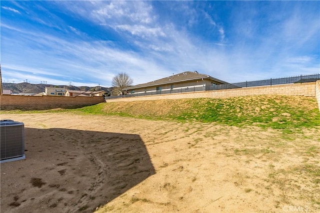 view of yard featuring fence and cooling unit