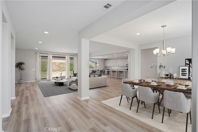 dining room featuring a chandelier, recessed lighting, visible vents, and light wood finished floors