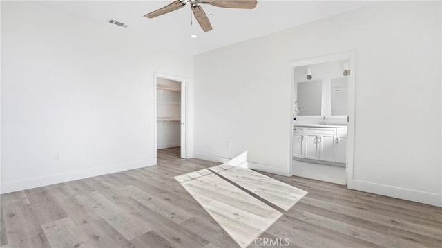 366 S Halcyon Rd, Arroyo Grande, CA 93420 - unfurnished bedroom featuring light wood-style flooring, ensuite bath, a closet, a spacious closet, and ceiling fan