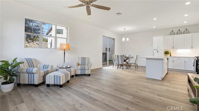 366 S Halcyon Rd, Arroyo Grande, CA 93420 - living room featuring recessed lighting, light wood finished floors, a ceiling fan, and a chandelier