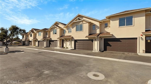 366 S Halcyon Rd, Arroyo Grande, CA 93420 - townhome / multi-family property featuring an attached garage, a residential view, stucco siding, and driveway