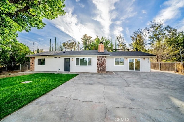 single story home featuring a front yard, fence, a chimney, and stucco siding