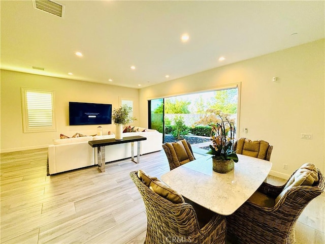 dining area featuring light wood-style flooring, visible vents, baseboards, and recessed lighting