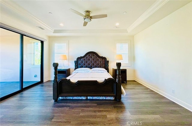 bedroom with a tray ceiling, multiple windows, and crown molding