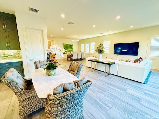 dining space with recessed lighting, visible vents, light wood-style flooring, and baseboards