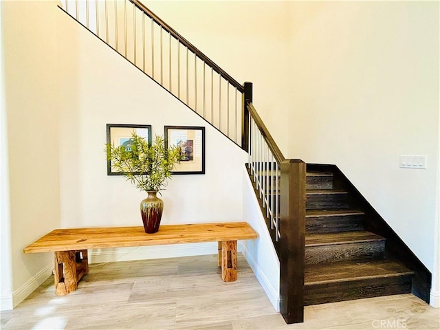 stairway featuring baseboards and wood finished floors