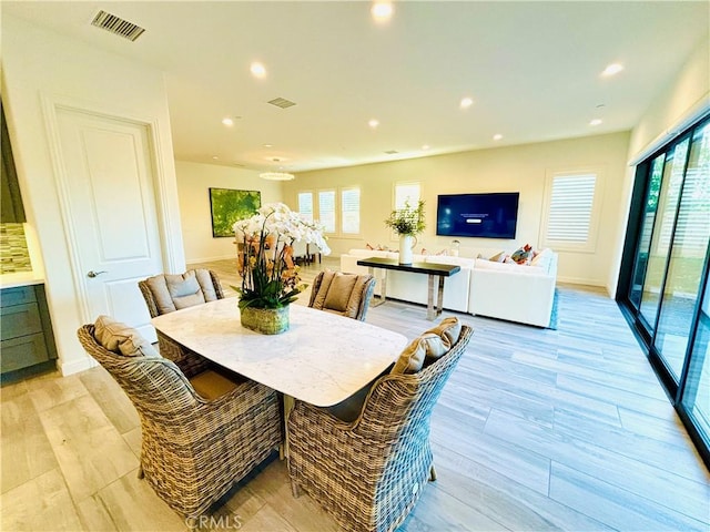 dining area with recessed lighting, visible vents, and light wood-style flooring