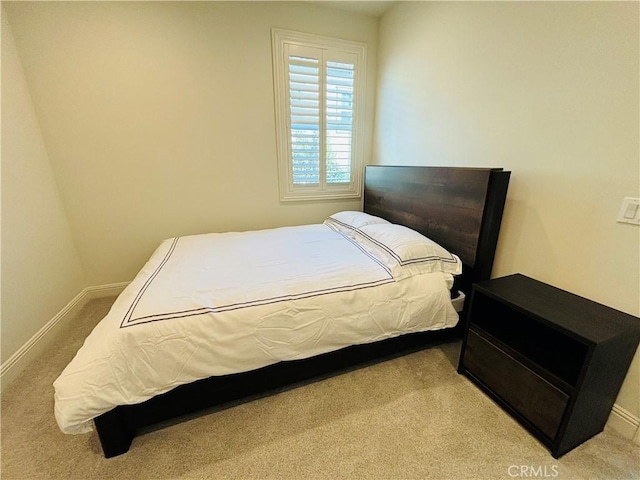 bedroom featuring baseboards and carpet flooring