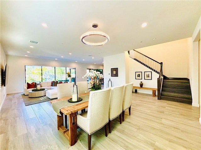 dining space featuring recessed lighting, visible vents, light wood-style floors, baseboards, and stairs