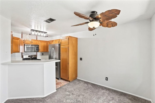 2568 Avenida Del Vis Unit 203, Corona, CA 92882 - kitchen featuring stainless steel appliances, light carpet, a ceiling fan, light countertops, and baseboards