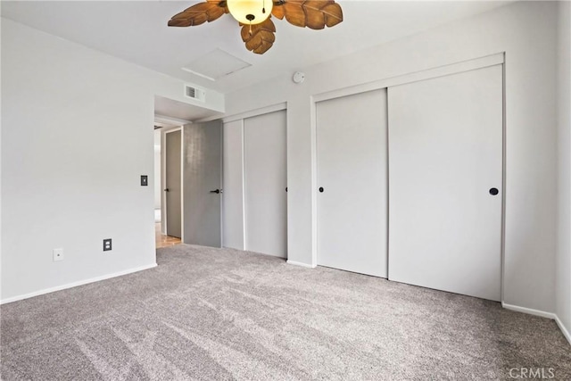2568 Avenida Del Vis Unit 203, Corona, CA 92882 - unfurnished bedroom with two closets, carpet floors, attic access, ceiling fan, and baseboards