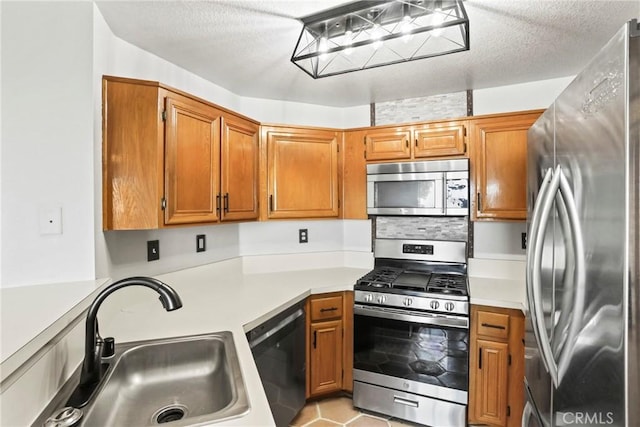 2568 Avenida Del Vis Unit 203, Corona, CA 92882 - kitchen with appliances with stainless steel finishes, a sink, light countertops, and brown cabinetry