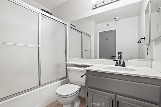 2568 Avenida Del Vis Unit 203, Corona, CA 92882 - bathroom featuring vanity, shower / bath combination with glass door, toilet, and wood finished floors