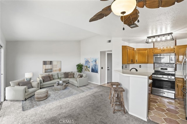 2568 Avenida Del Vis Unit 203, Corona, CA 92882 - living room with ceiling fan, dark carpet, baseboards, and lofted ceiling