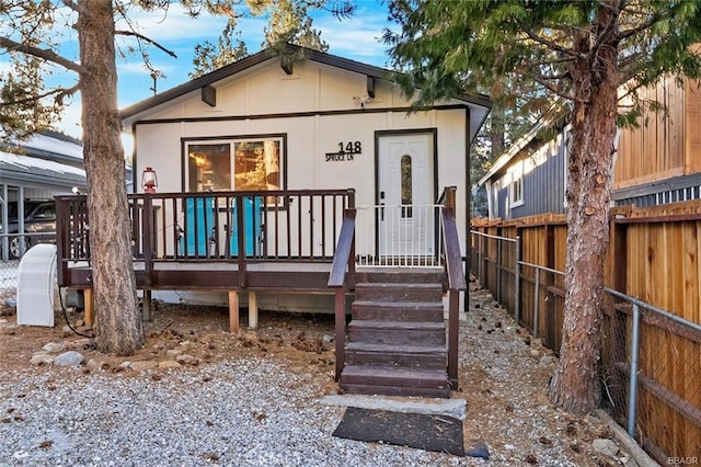 view of front facade featuring fence and a deck