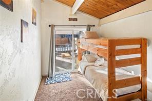 bedroom featuring lofted ceiling with beams and wood ceiling