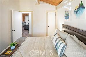 bedroom with lofted ceiling and wood ceiling