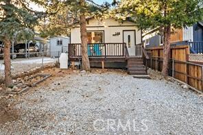 view of front of house with fence and a deck