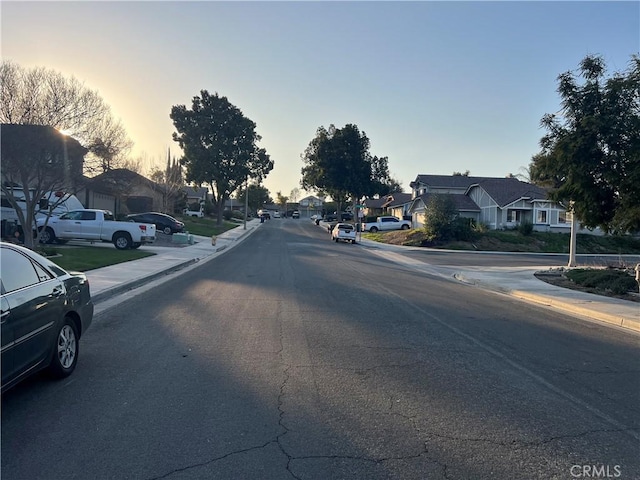 view of road with curbs, sidewalks, and a residential view