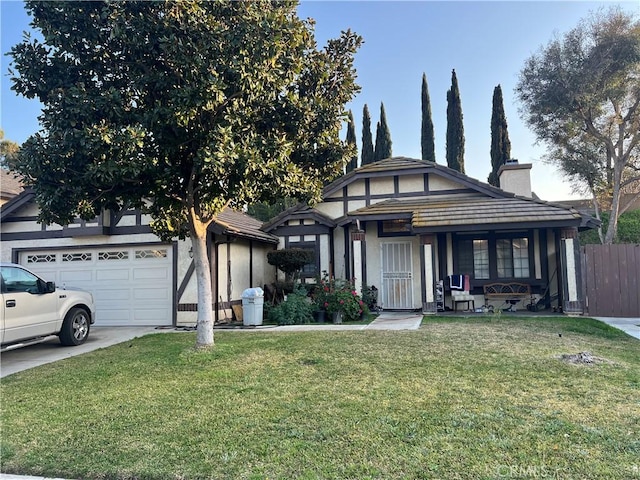 view of front of property featuring driveway, a garage, a chimney, fence, and a front lawn