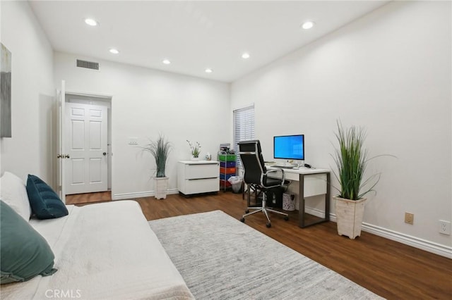 bedroom with baseboards, wood finished floors, visible vents, and recessed lighting